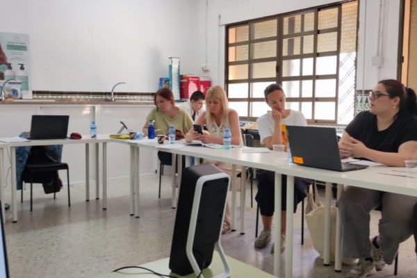 Partners sitting around the tables in the meeting room.